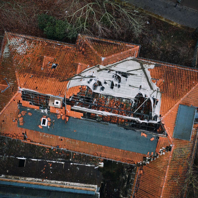 Image showcasing storm damage leading to roof leaks