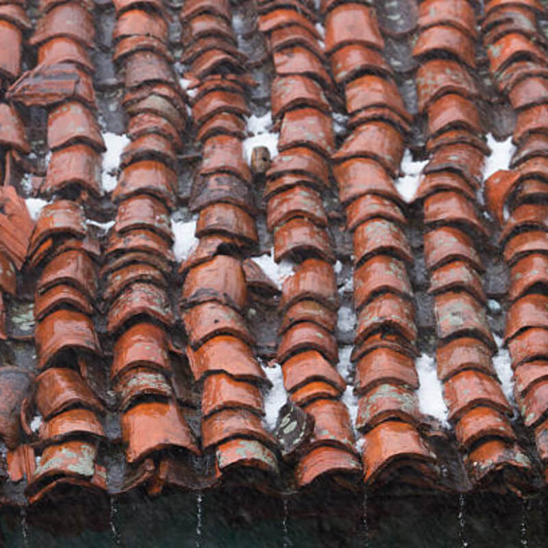 Image demonstrating the impact of hail on a roof causing emergency roof leaks.