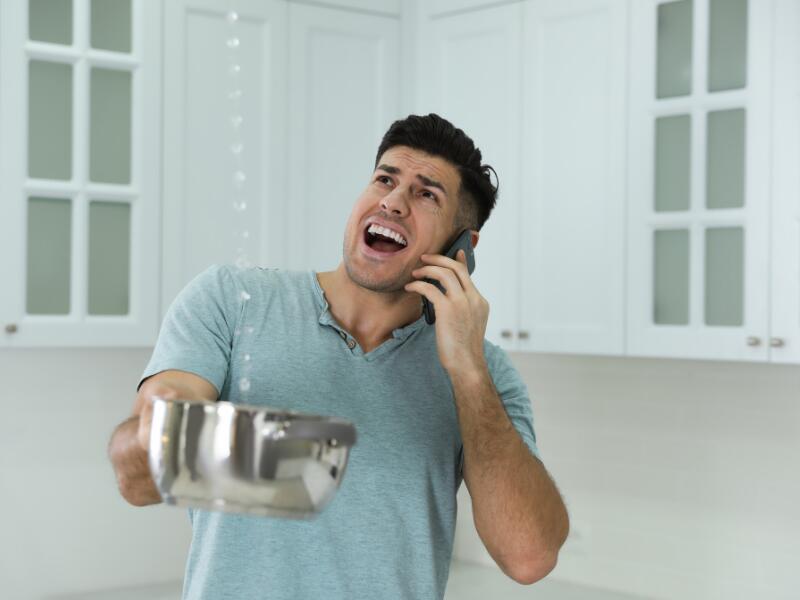 Picture of a homeowner contemplating roof repair or replacement of the entire roof.