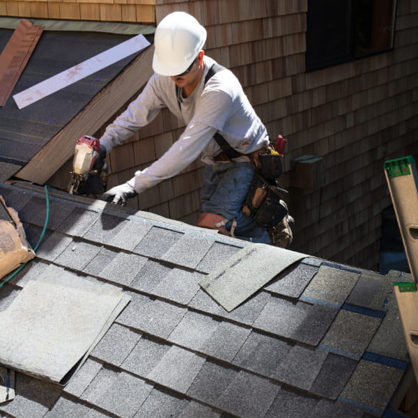 An image showing a team of professional roofers working on a residential roof in Cordova, TN.